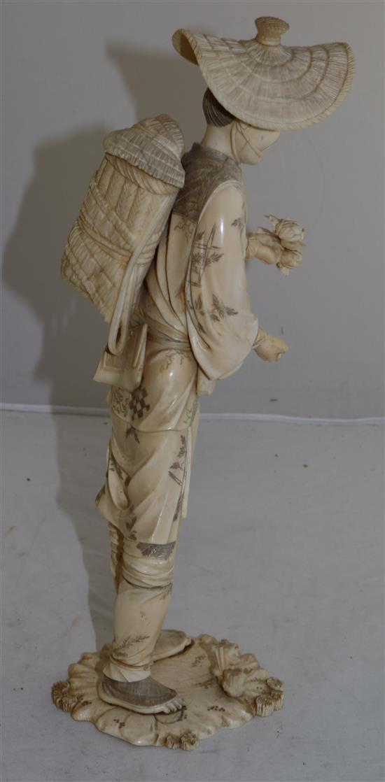 A large Japanese sectional ivory figure of a farmer, early 20th century, 36.5cm